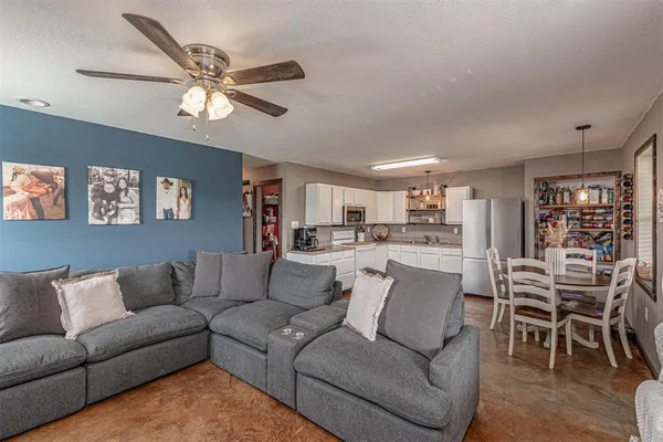 a living room with furniture and kitchen view