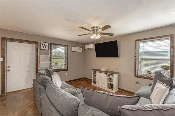 a living room with furniture and a flat screen tv