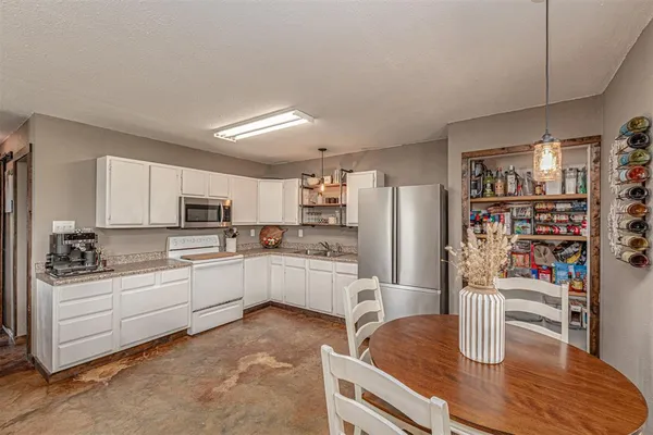 a kitchen with stainless steel appliances granite countertop a sink and refrigerator