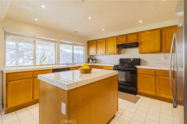 a kitchen that has a sink and a stove in it