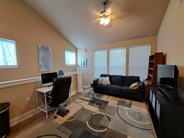 a living room with furniture a piano and a window