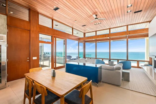 a living room with fireplace furniture and a floor to ceiling window