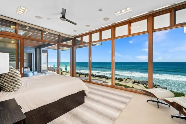 a bedroom with a large window and a bed