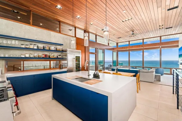 a room with pool table and large windows