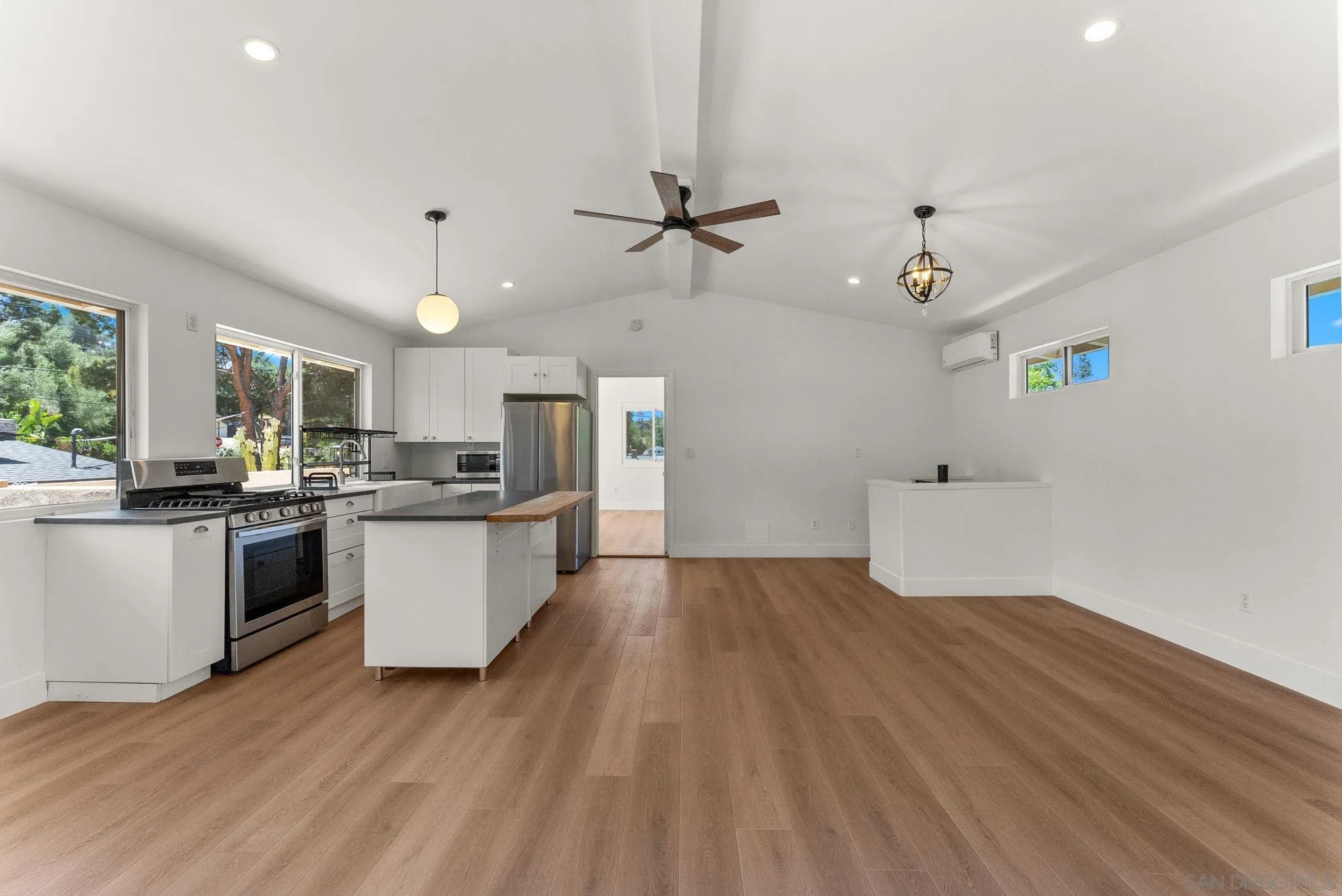 12832 Stone Canyon Road Poway, CA 92064 - Photo 37 of 60 a large kitchen with cabinets wooden floor and stainless steel appliances