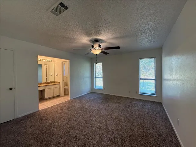 a view of a livingroom with a ceiling fan and window