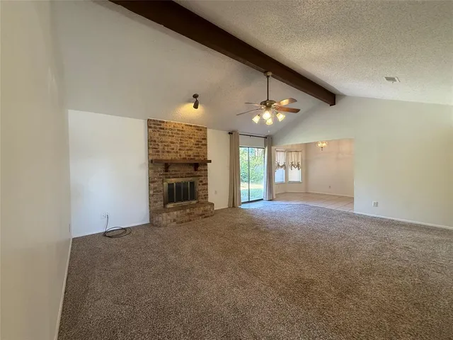 a view of an empty room with a fireplace