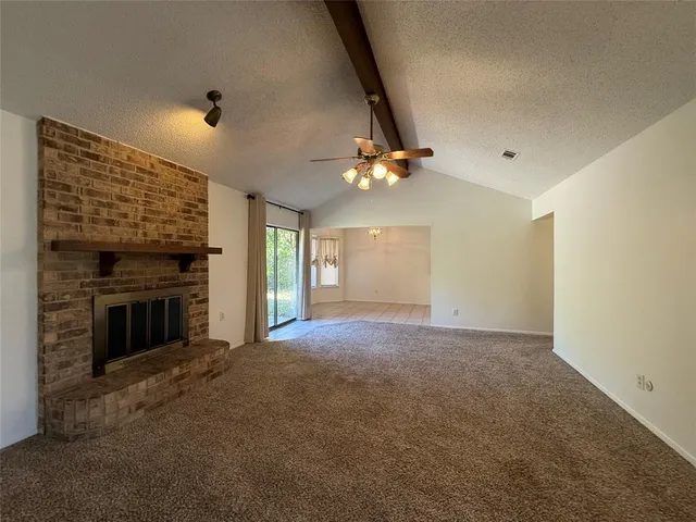 a view of an empty room with a fireplace
