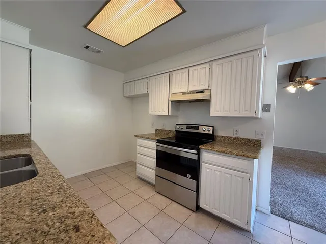 a kitchen with a stove and a sink