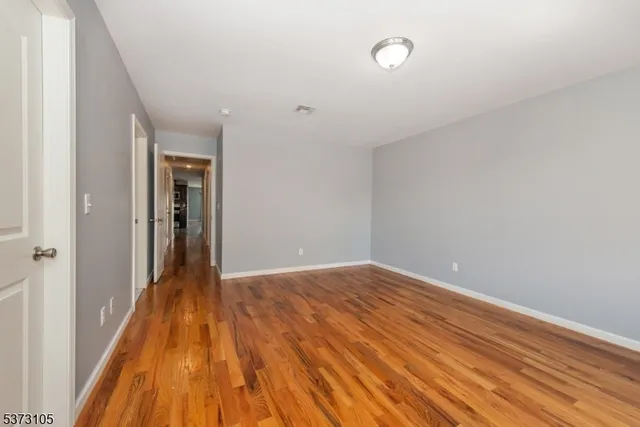 a view of hallway with wooden floor
