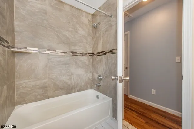 a bathroom with a tub and shower
