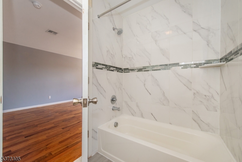 848 Lafayette Street Elizabeth, NJ 07201 - Photo 19 of 21 a bathroom with a bathtub and a shower