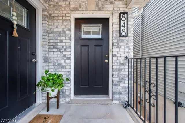 a front view of a house with a potted plant