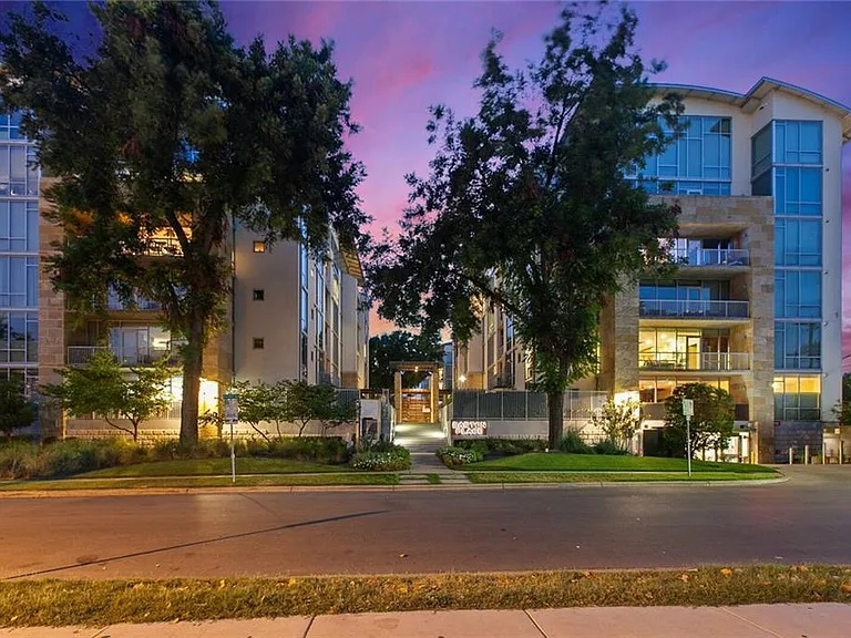 1600 Barton Springs Road, Unit 5110 Austin, TX 78704 - Photo 29 of 31 Experience modern living in this residential complex, showcasing a sophisticated exterior with multiple balconies and a well-maintained entrance.