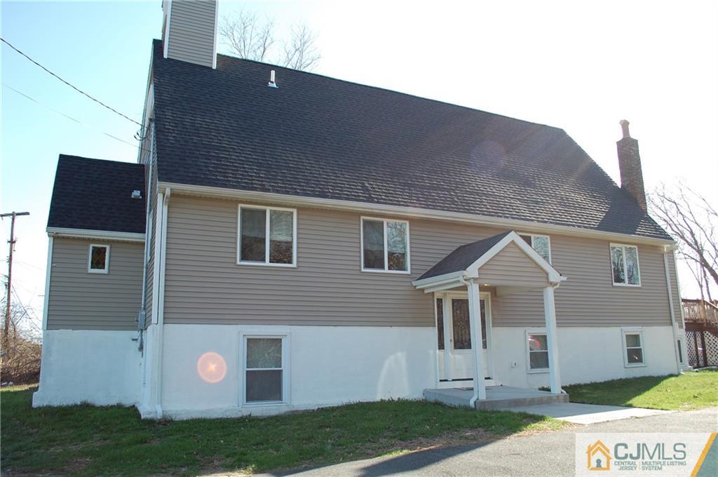 146 Cottrell Road Old Bridge, NJ 07747 - Photo 1 of 25 a front view of a house with a yard