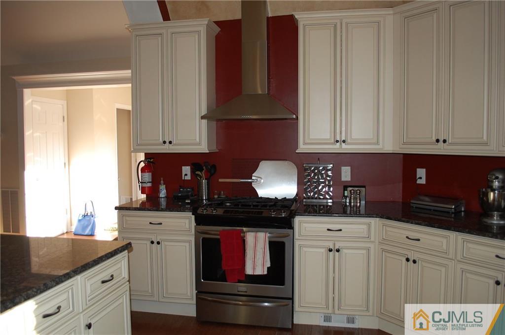 146 Cottrell Road Old Bridge, NJ 07747 - Photo 5 of 25 a kitchen with stainless steel appliances granite countertop a refrigerator and cabinets