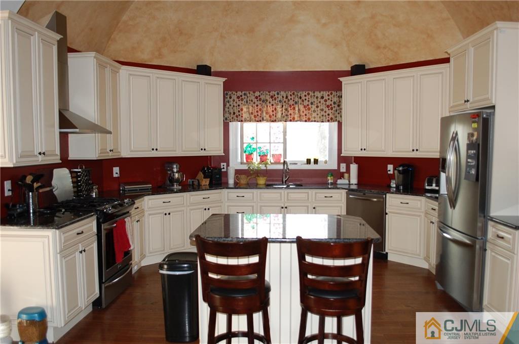 146 Cottrell Road Old Bridge, NJ 07747 - Photo 7 of 25 a kitchen with stainless steel appliances a stove a sink a microwave a refrigerator and cabinets