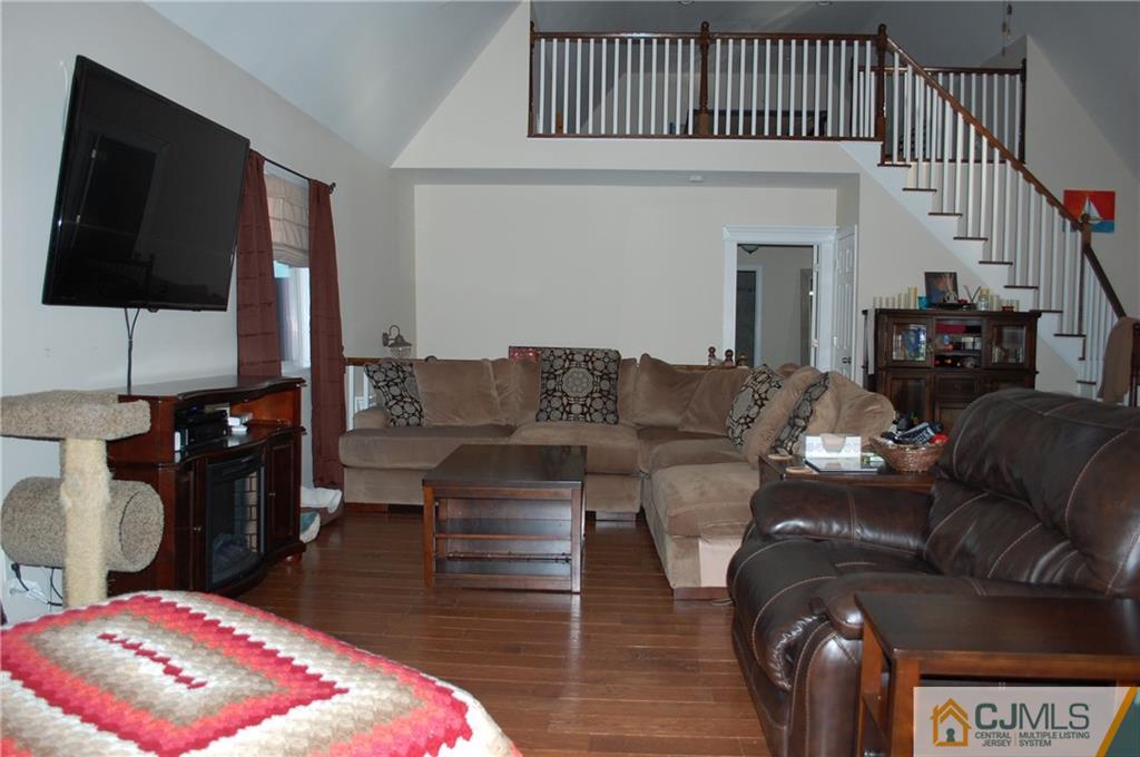146 Cottrell Road Old Bridge, NJ 07747 - Photo 9 of 25 a living room with furniture a flat screen tv and a rug