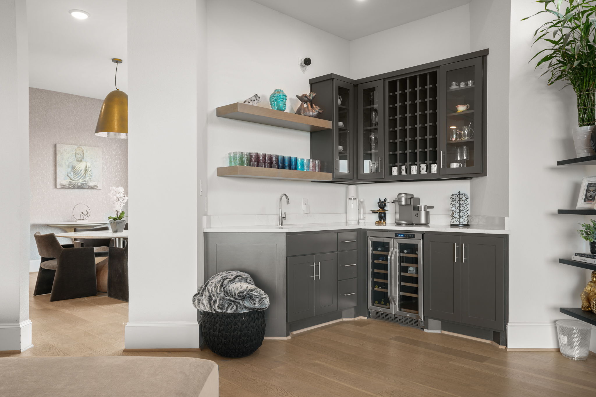 104 Lodestone Cove Austin, TX 78738 - Photo 13 of 40 A well-appointed wet bar with wine storage and floating shelves integrates seamlessly into the open living space.