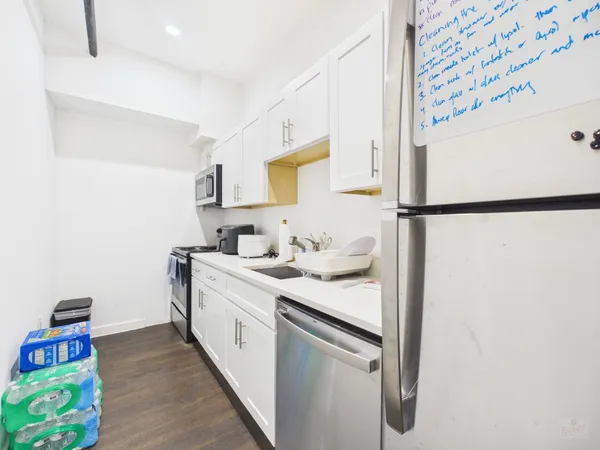 a kitchen with a sink a refrigerator and a stove