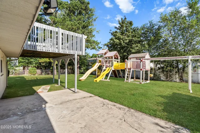 a view of a house with a backyard and a table and chairs
