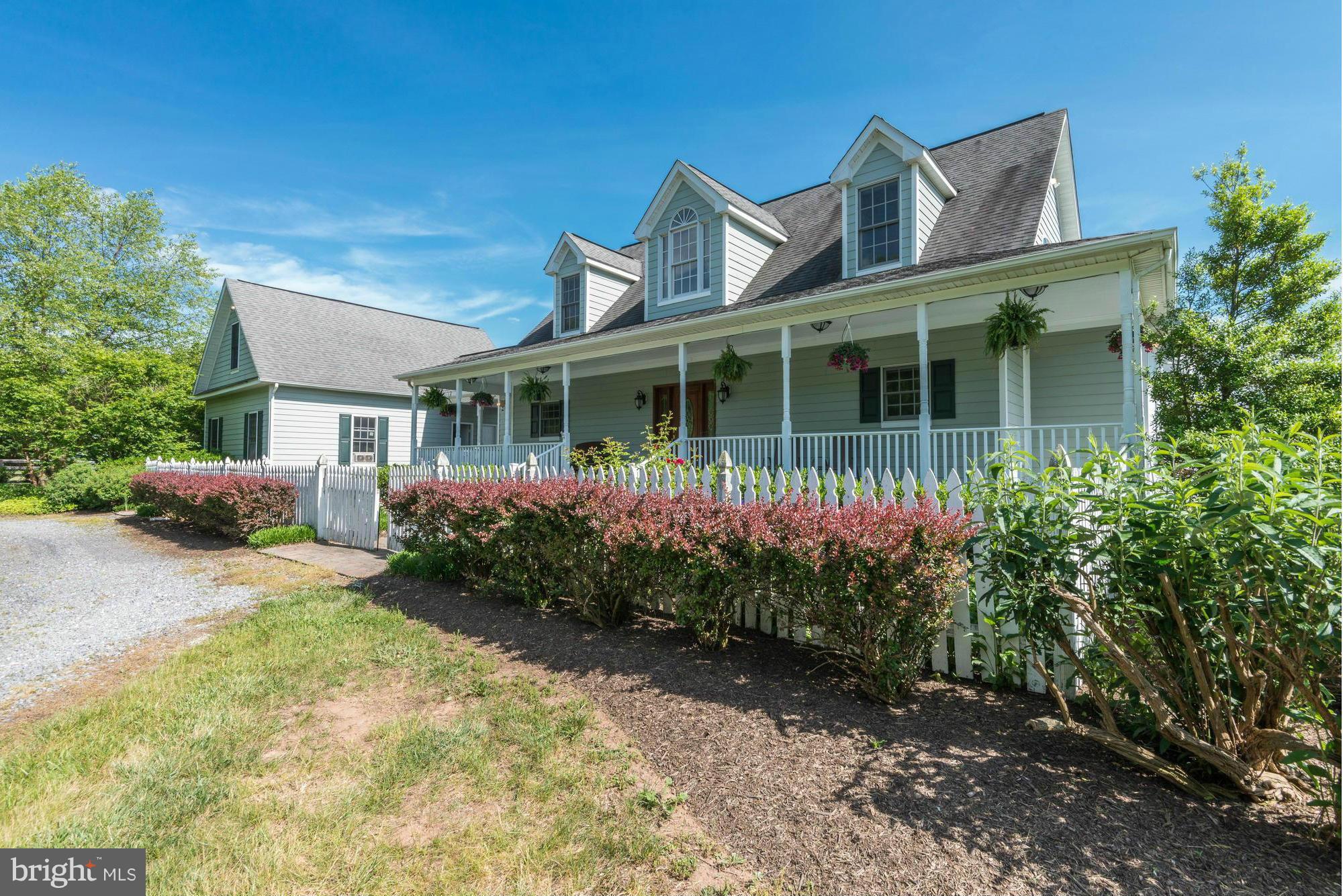 20500 Westerly Road Poolesville, MD 20837 - Photo 1 of 30 a front view of a house with garden
