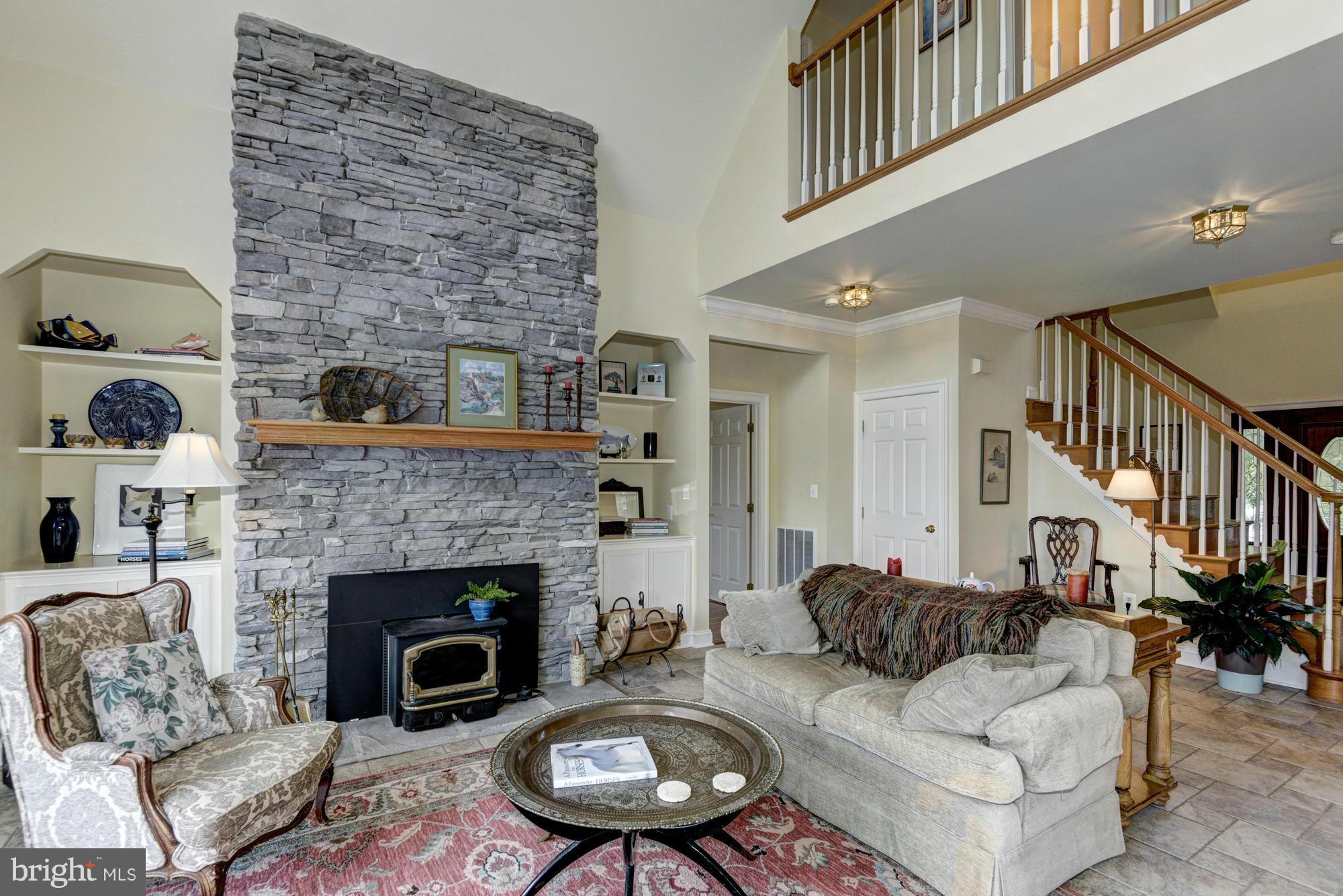 20500 Westerly Road Poolesville, MD 20837 - Photo 11 of 30 a living room with furniture and a fireplace
