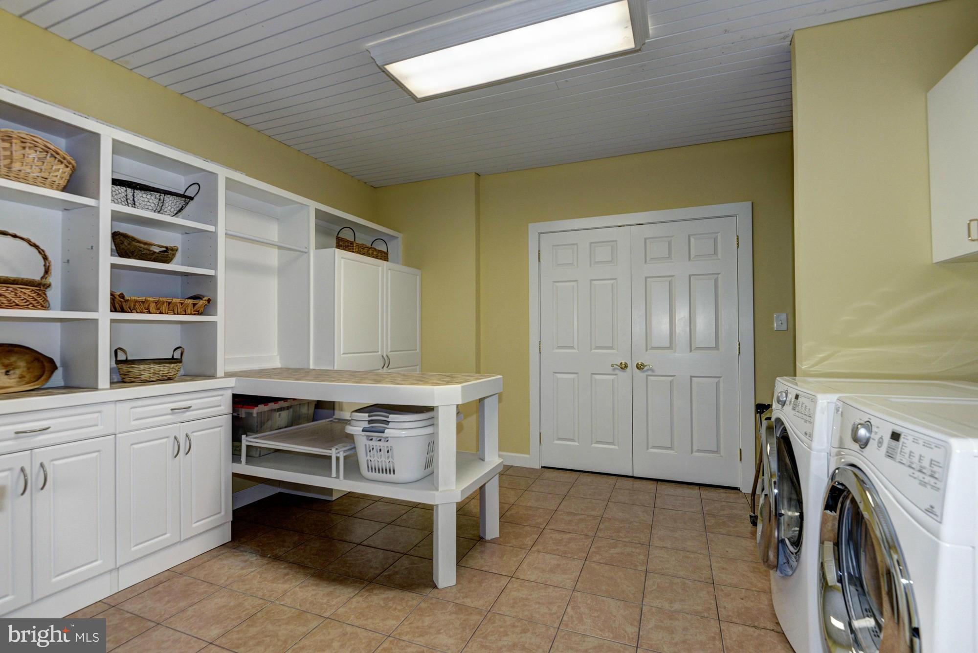 20500 Westerly Road Poolesville, MD 20837 - Photo 25 of 30 a utility room with cabinets dryer and washer