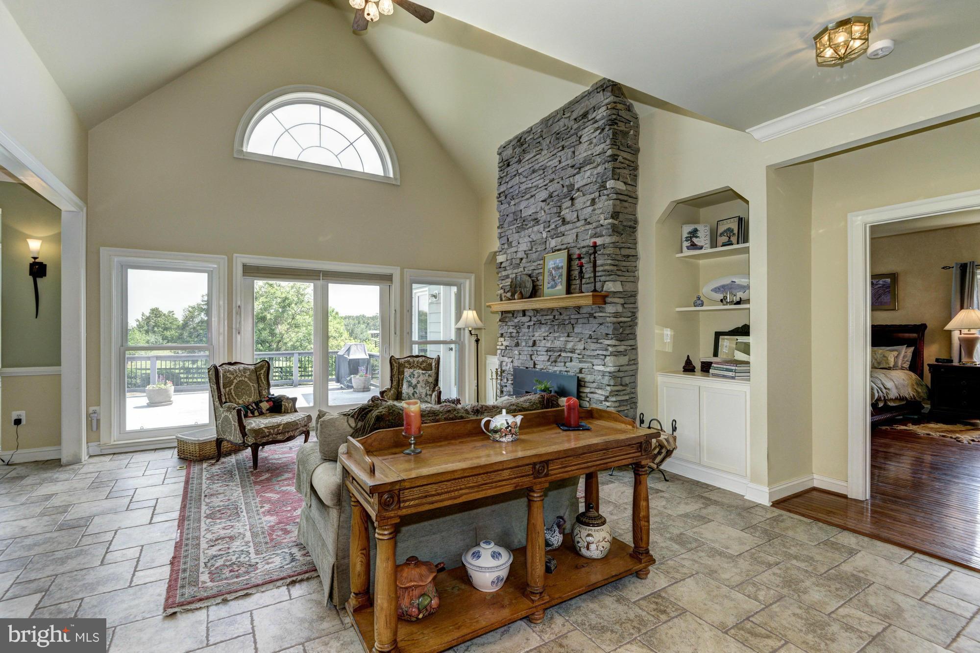 20500 Westerly Road Poolesville, MD 20837 - Photo 10 of 30 a living room with furniture and a fireplace