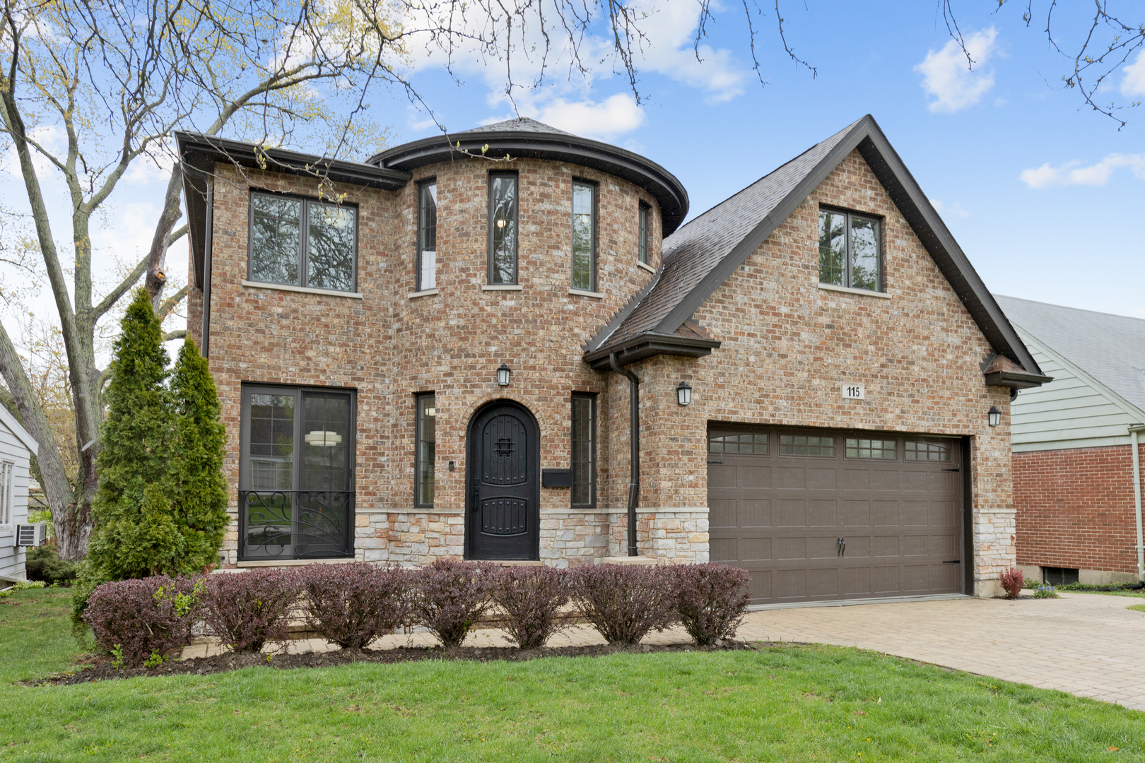 115 Washington Street Glenview, IL 60025 - Photo 1 of 40 a front view of a house with a garden and plants