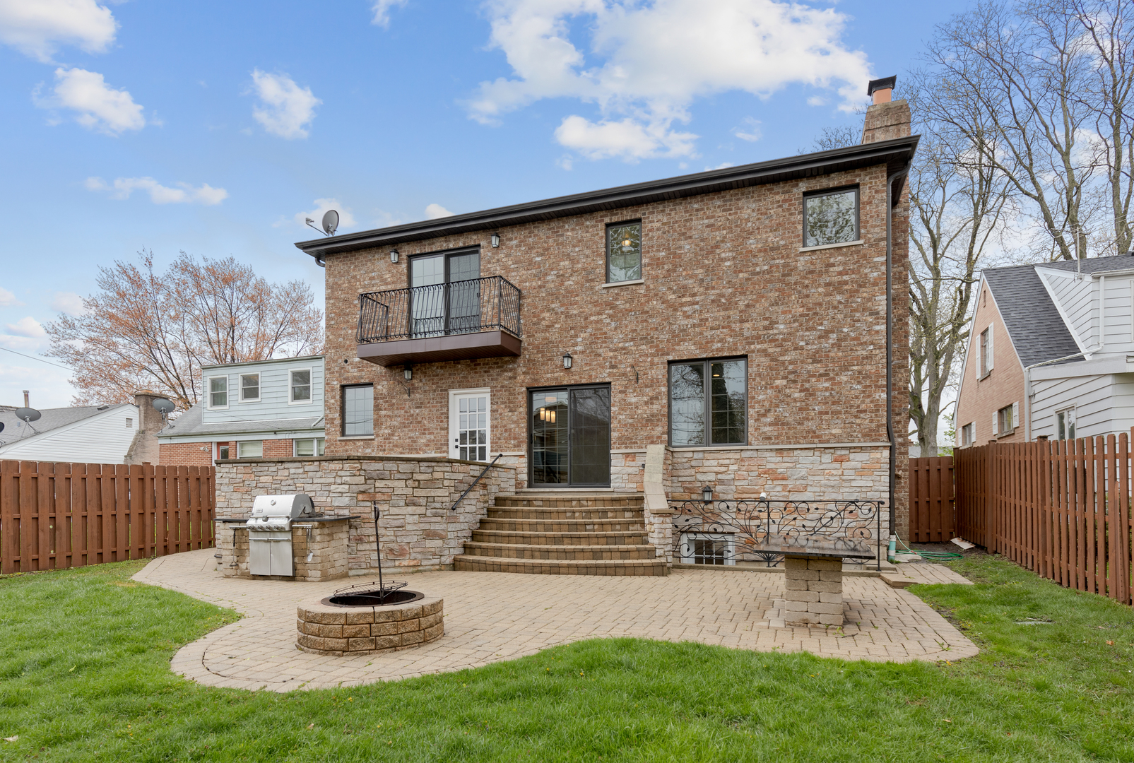 115 Washington Street Glenview, IL 60025 - Photo 15 of 40 a view of a backyard with table and chairs and wooden fence