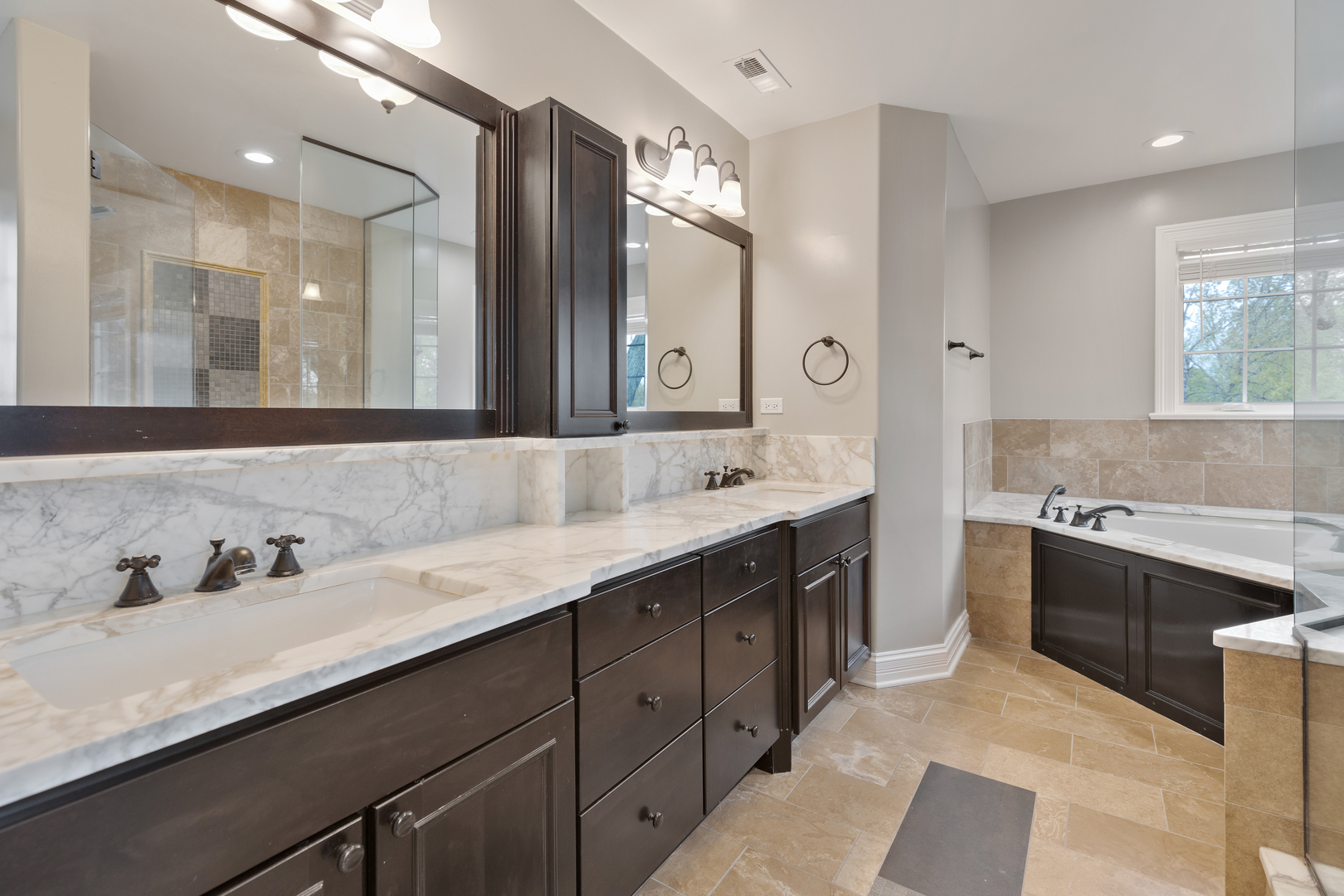 115 Washington Street Glenview, IL 60025 - Photo 20 of 40 a spacious bathroom with a granite countertop double vanity sink a mirror and a shower