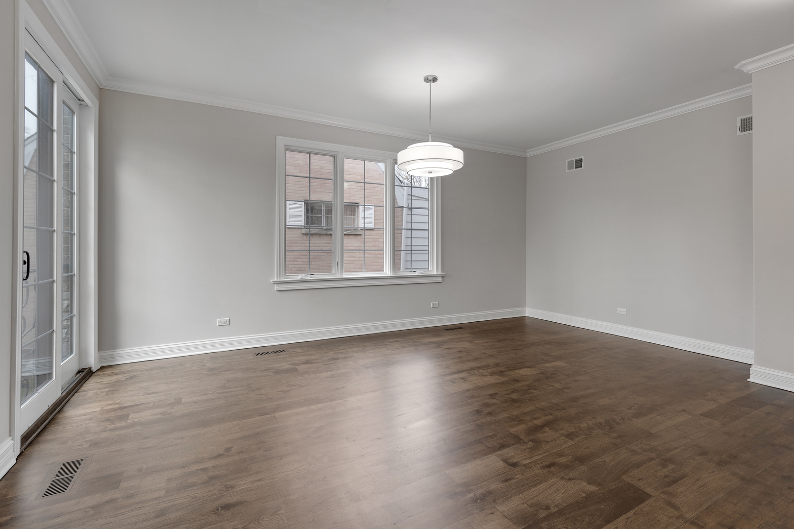 115 Washington Street Glenview, IL 60025 - Photo 5 of 40 an empty room with wooden floor fan and windows