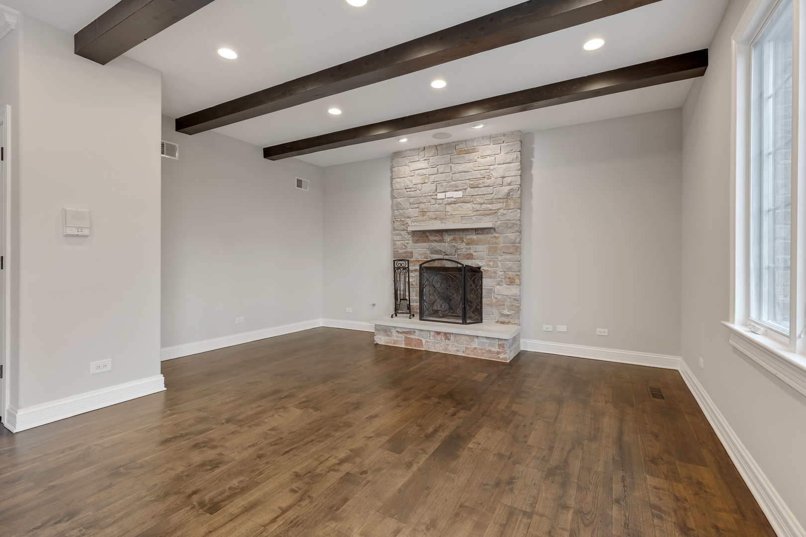 115 Washington Street Glenview, IL 60025 - Photo 7 of 40 a view of an empty room with wooden floor and a window