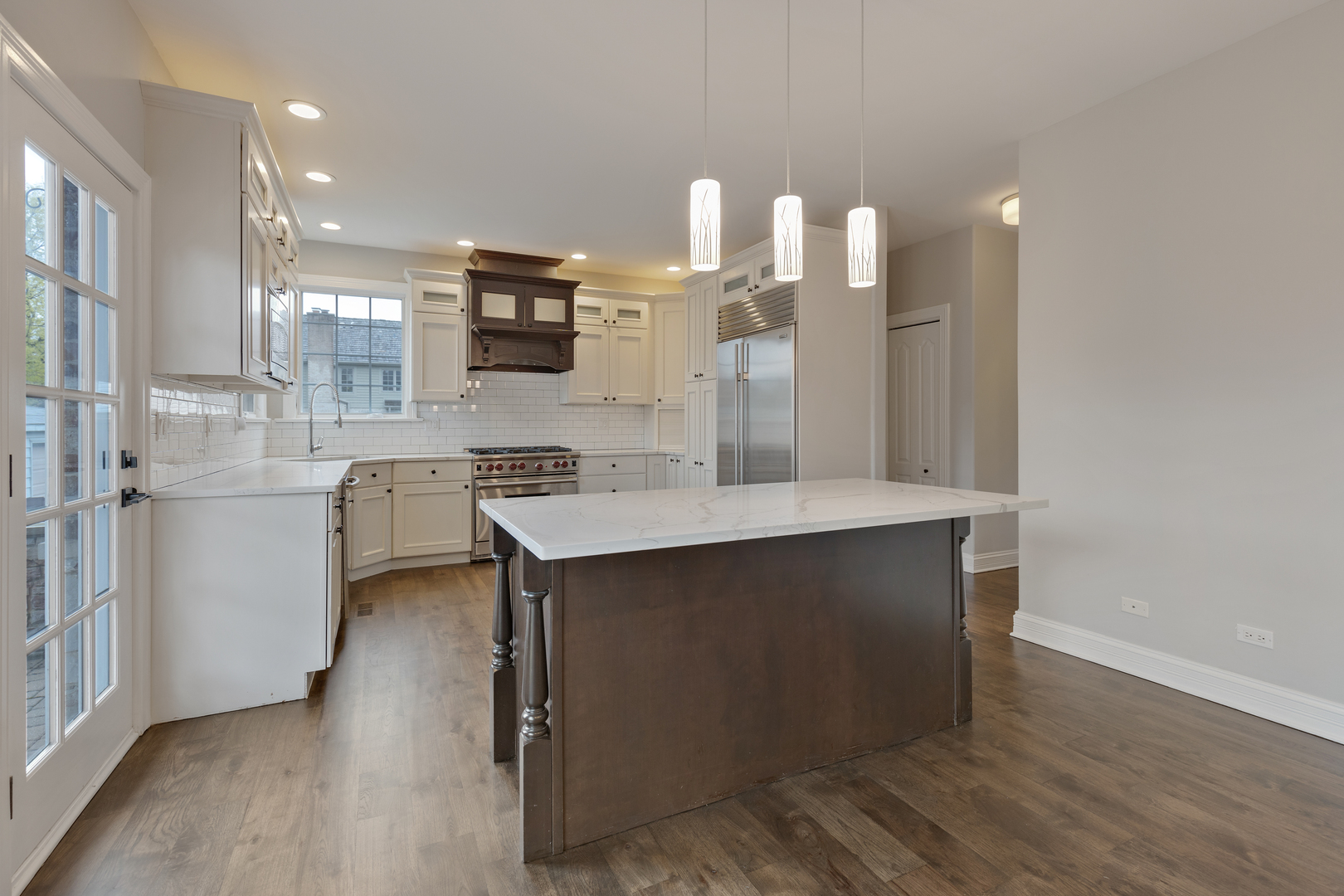 115 Washington Street Glenview, IL 60025 - Photo 9 of 40 a kitchen with a sink cabinets and wooden floor