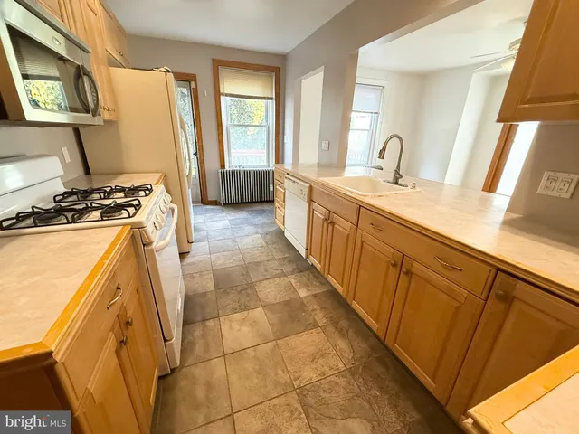 a kitchen with sink a stove and refrigerator