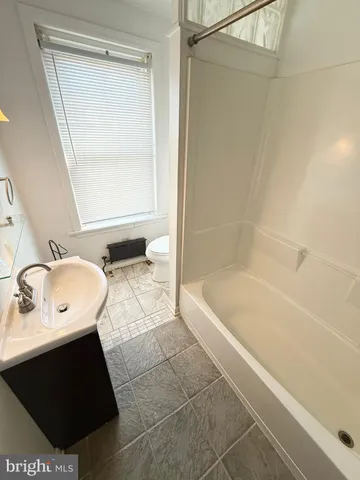 a bathroom with a sink a mirror and a bathtub