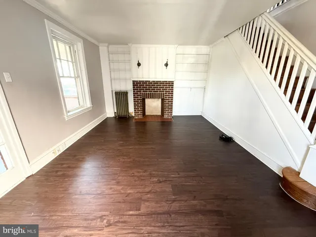 wooden floor in an empty room with a fireplace