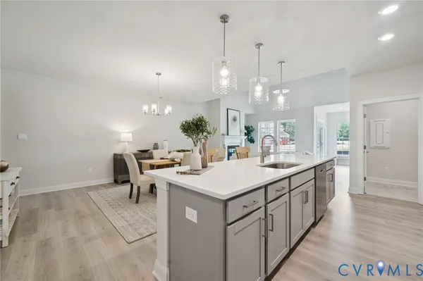 a kitchen with kitchen island a sink table and chairs