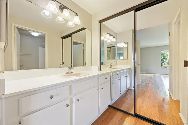 a spacious bathroom with a double vanity sink mirror and