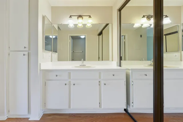 a bathroom with a sink vanity and a mirror