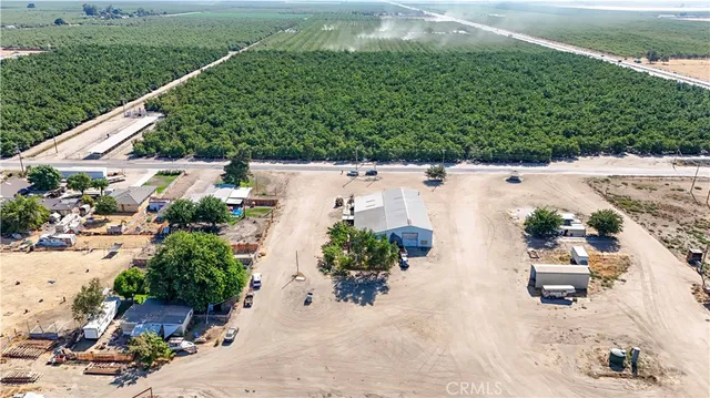 an aerial view of a house with a yard and sitting area
