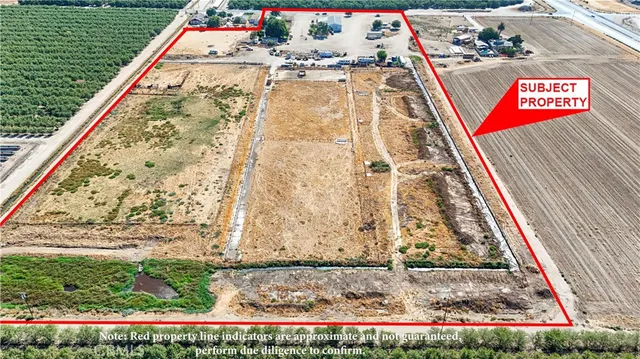 a tall yellow building with trees in front of it