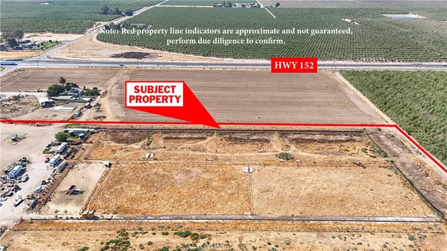 an aerial view of a house with a yard and parking