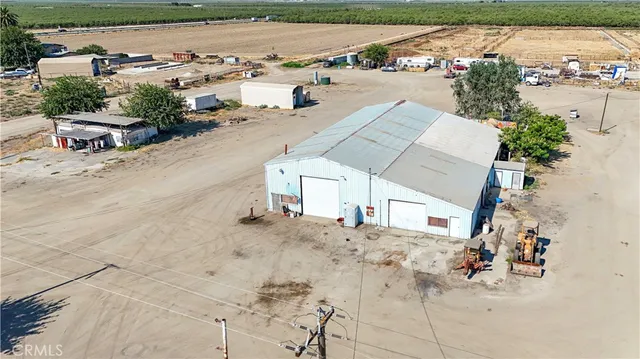 an aerial view of a house with a yard and trees