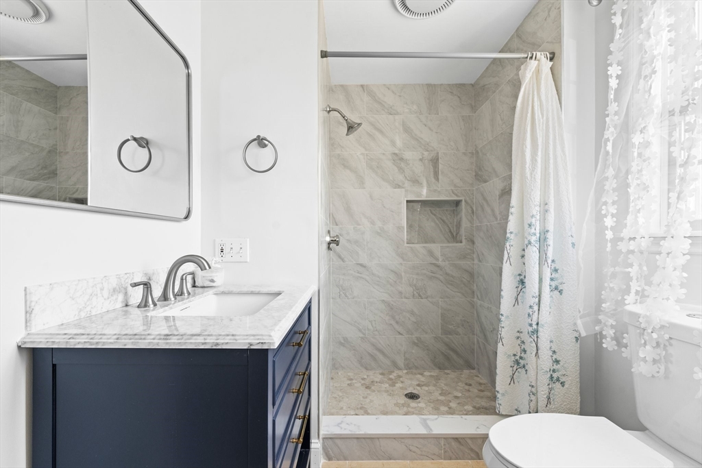 24 Battle Green Road Lexington, MA 02421 - Photo 11 of 25 a bathroom with a sink and a mirror