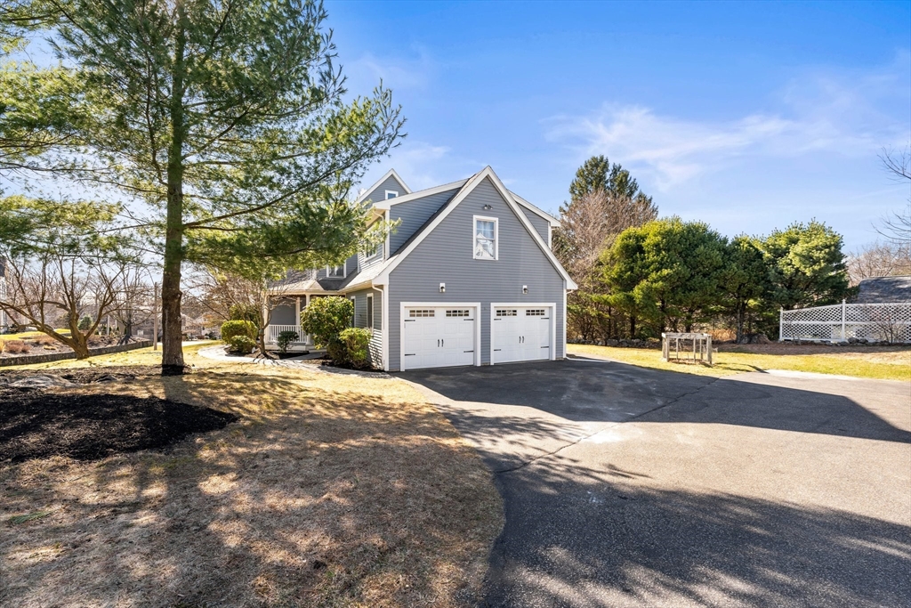 24 Battle Green Road Lexington, MA 02421 - Photo 3 of 25 a front view of a house with a yard and garage