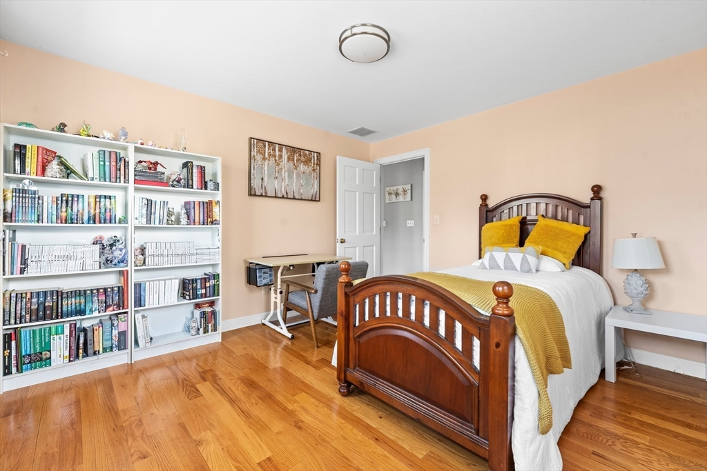 24 Battle Green Road Lexington, MA 02421 - Photo 8 of 25 a bedroom with a bed next to a book shelf