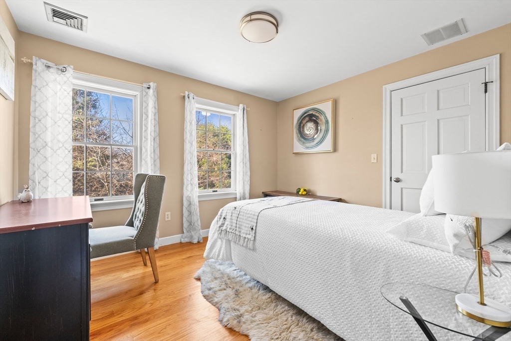 24 Battle Green Road Lexington, MA 02421 - Photo 9 of 25 a bedroom with a bed and wooden floor