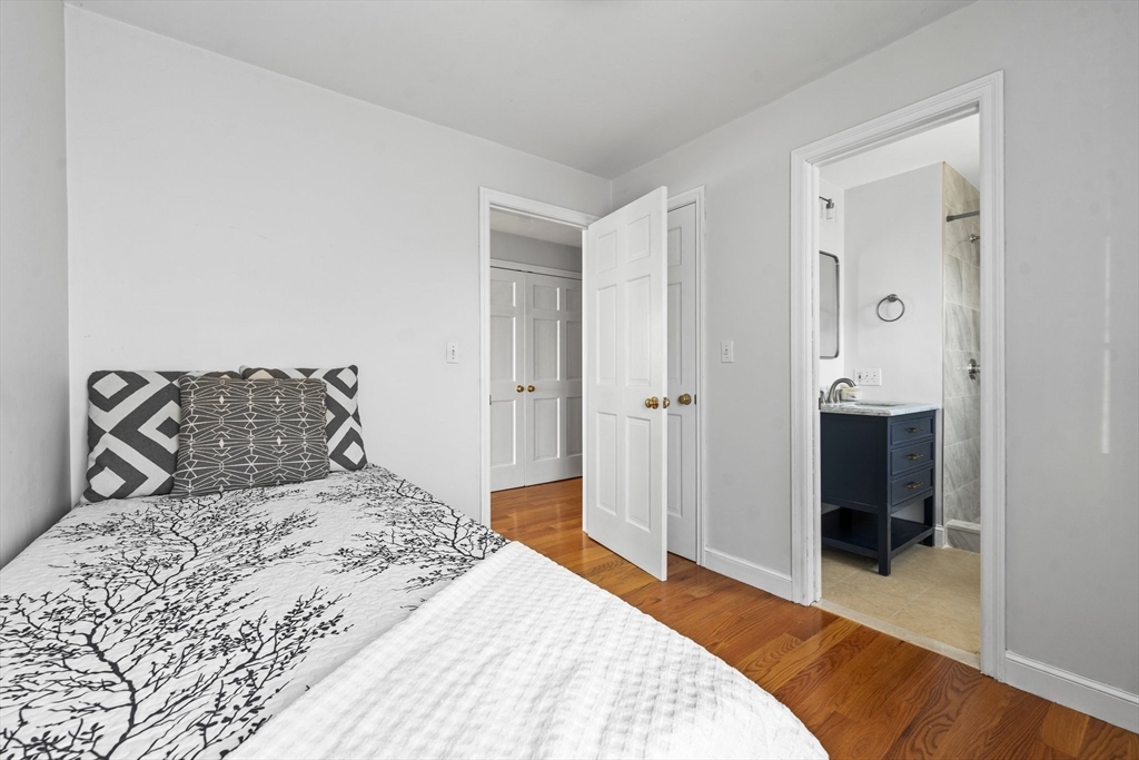 24 Battle Green Road Lexington, MA 02421 - Photo 10 of 25 a bedroom with a bed and a view of bathroom